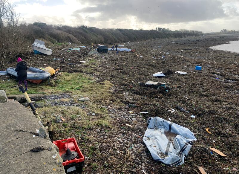 A boat was washed off its moorings at Galway Bay Sailing Club near Oranmore leaving it and other debris stranded on the beach. Photograph: Ed Carty/PA Wire
