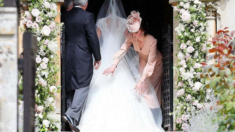 Britain’s Duchess of Cambridge Kate Middleton (right) arranges the train of her sister Pippa . Photograph: Kirsty Wrigglesworth/Reuters