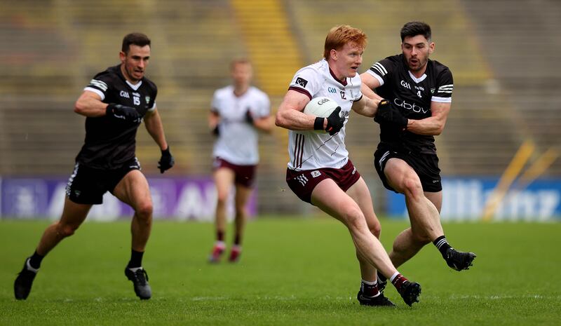 Nathan Mullen grapples with Peter Cooke (centre) for possession during the Connacht SFC final between Sligo and Galway. Photograph: Ryan Byrne/Inpho