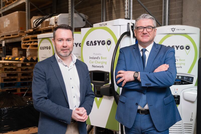 EasyGo CEO Kelly and AIB’s head of SME banking Brennan in front of several of the charging points at its HQ in Maynooth