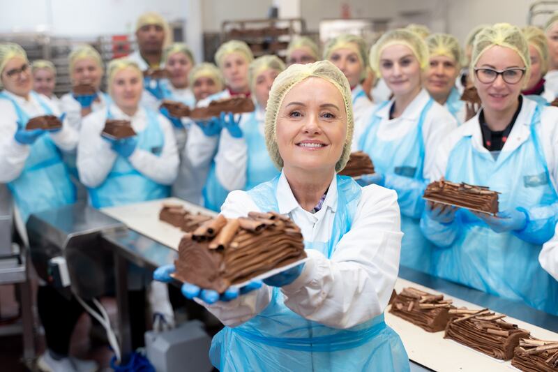 Pic: The co-founding queen of Christmas chocolate treats, Couverture sales director Celine Hayes, with her team and their yule log, inspired by co-founder Margaret Lynch’s grand-aunt’s recipe book