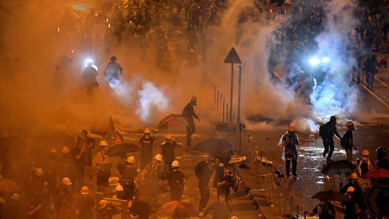 Police fire tear gas at protesters near the government headquarters in Hong Kong.  Riot police fired  as they charged anti-government protesters in the early hours of the morning of July 2nd (local time). Photograph:  Anthony Wallace/AFP/Getty
