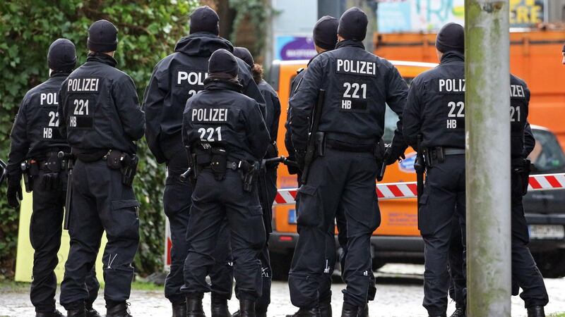 Police officers stand in the backyard of the Goetheplatz theater where Frank Magnitz, was attacked in Bremen, Germany. Photograph: Focke Strangmann/EPA