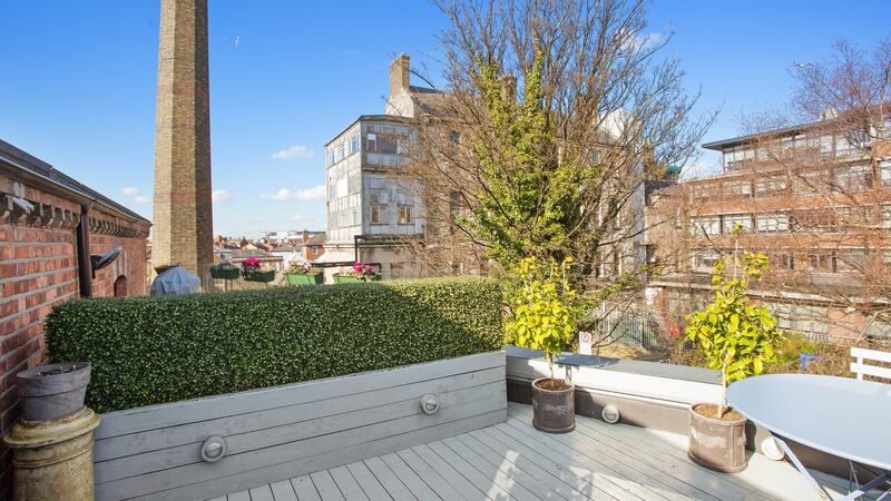 The backdrop to the roof terrace at  47 Arnott Street is an old towering chimney from the Meath Hospital.