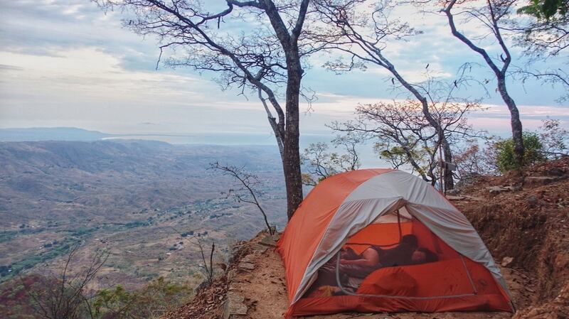 The couple camped along the route, like here in Malawi. Photograph: Simplycycling.org via The New York Times