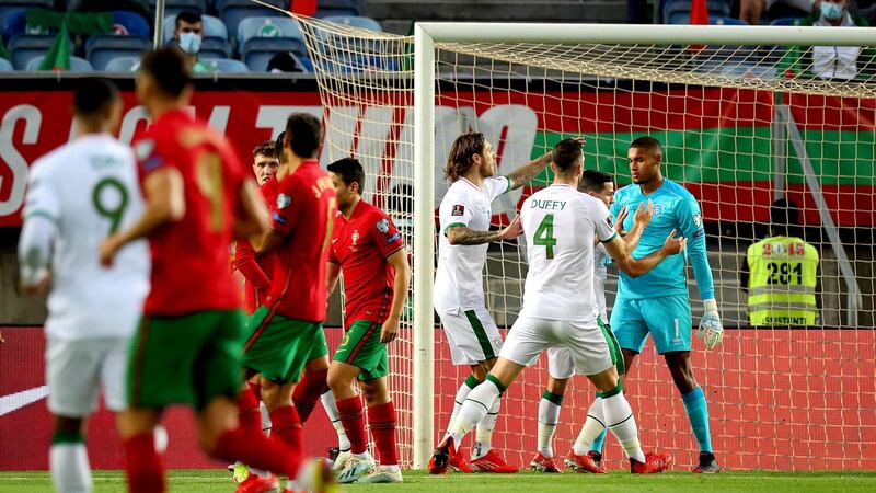Ireland goalkeeper Gavin Bazunu is congratulated by team-mates after saving Cristiano Ronaldo’s penalty kick during the World Cup qualifier. Photograph: Ryan Byrne/Inpho