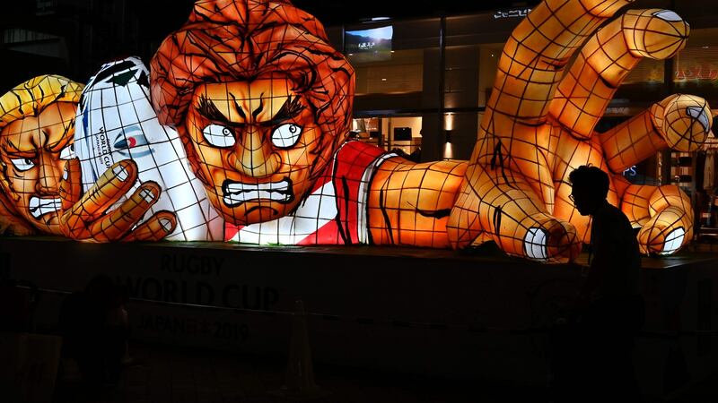 A pedestrian walks by an advertising installation for the Japan 2019 Rugby World Cup in Oita on the eve of the start of the tournament. Photo: Gabriel Bouys/Getty Images