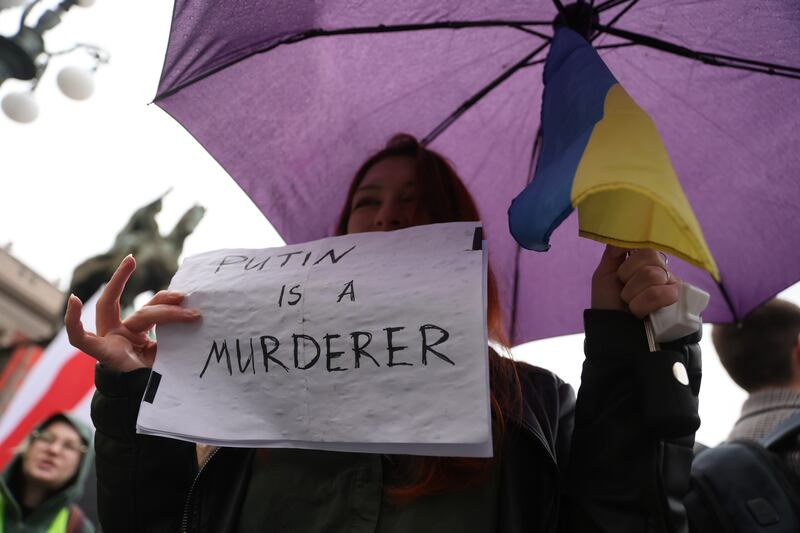 A protestor holds a banner during a rally  organised by the Russian Democratic Society in Serbia in Belgrade. Photogaph: Andrej Cukic/EPA