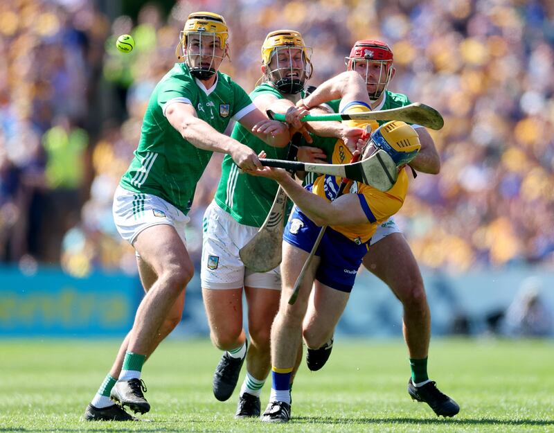 Limerick’s Cathal O'Neill, Tom Morrissey and Barry Nash tackling Seadna Morey of Clare. Photograph: James Crombie/Inpho