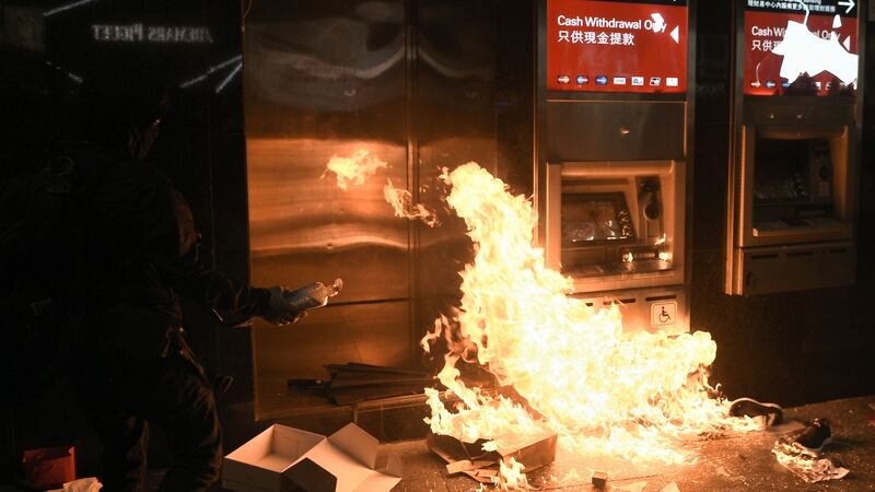 A protester sets fire to an ATM outside an HSBC branch in  in Hong Kong on January 1st, 2020. Photograph: Philip Fong/AFP/ Getty Images.