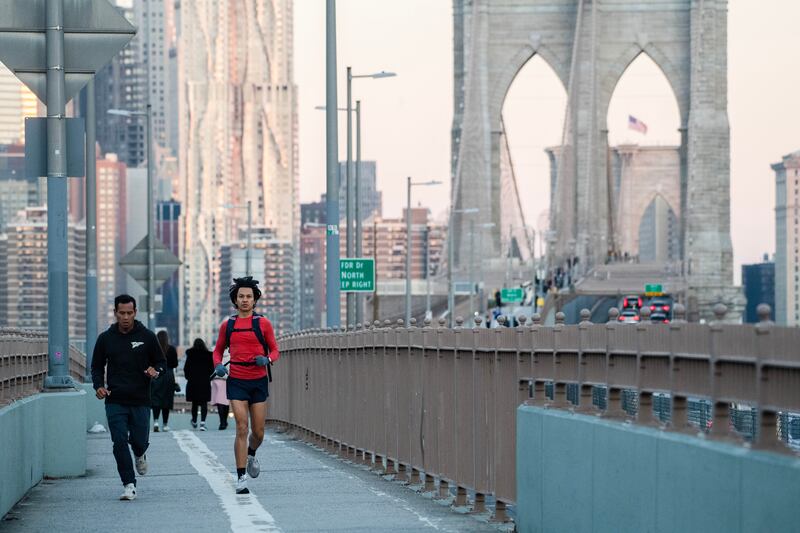Runners cross the Brooklyn Bridge during the New York marathon. Photograph: Brittainy Newman/The New York Times
                    