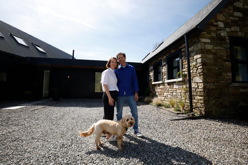 Nell and Conor outside their H-shaped home