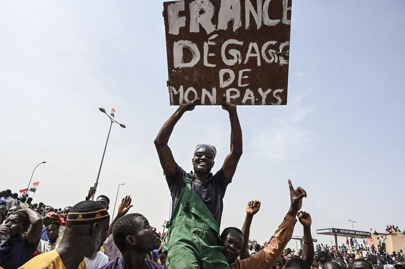 A man holds a placard urging France to get out of Niger at a protest last week outside the Niger and French airbase in the capital, Niamey. Photograph: AFP via Getty Images