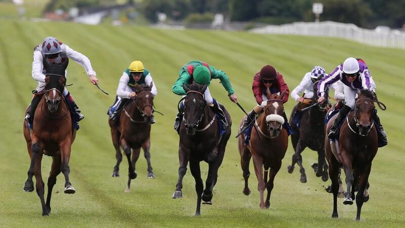 Johnny Murtagh on Ambivalent (left) comes home to win the fourth race of the day.  Photograph: Lorraine O’Sullivan/Inpho