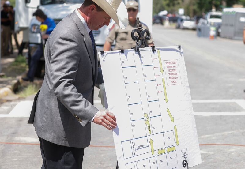 A law enforcement officer displays a graphic showing the route taken by gunman Salvador Ramos into Robb Elementary School in Uvalde.