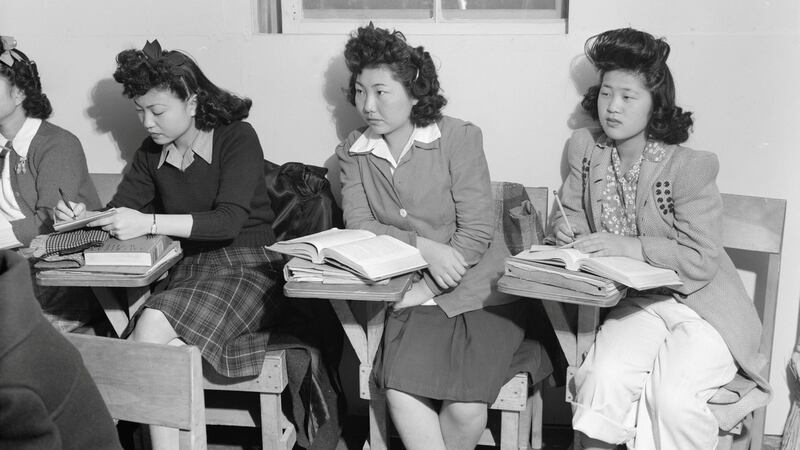 Interned: Three young Japanese-American women in a  classroom at a relocation centre in California in 1943. Photograph: Ansel Adams/Library of Congress/Reuters