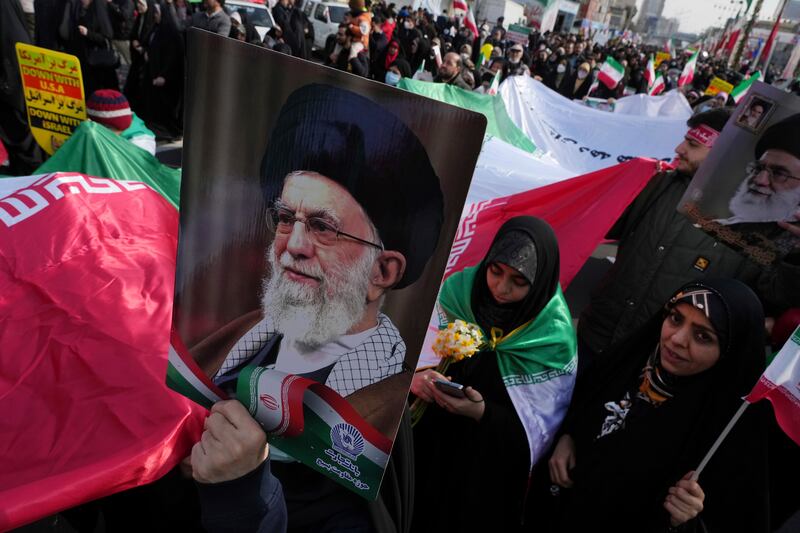 Demonstrators carry an Iranian flag and posters of the supreme leader, Ayatollah Ali Khamenei, during a rally commemorating Iran’s 1979 Islamic revolution, in Tehran in February last year. Photograph: Vahid Salemi/AP