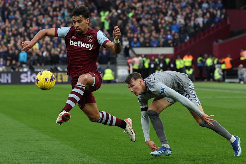 West Ham United's Brazilian midfielder #10 Lucas Paqueta (L) controls the ball as he leaves Everton's Scottish defender #02 Nathan Patterson (R) standing during the English Premier League football match between West Ham United and Everton at the London Stadium, in London on October 29, 2023. (Photo by Adrian DENNIS / AFP) / RESTRICTED TO EDITORIAL USE. No use with unauthorized audio, video, data, fixture lists, club/league logos or 'live' services. Online in-match use limited to 120 images. An additional 40 images may be used in extra time. No video emulation. Social media in-match use limited to 120 images. An additional 40 images may be used in extra time. No use in betting publications, games or single club/league/player publications. /  (Photo by ADRIAN DENNIS/AFP via Getty Images)