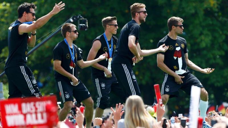 Germany players Mats Hummels, Philipp Lahm, Erik Durm, Benedikt Höwedes and Thomas Müller  play air guitar on  stage during celebrations to mark the team’s 2014  World Cup victory in berlin. Photograph: Thomas Peter/Reuters