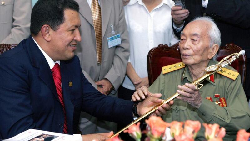 Venezuela’s then president Hugo Chavez (left) offers a sword, similar to the one used by Venezuela’s hero Simon Bolivar, to Vietnam’s General Vo Nguyen Giap at his home in Hanoi in 2006. Photograph: Hoang Dinh Nam/Pool/Files