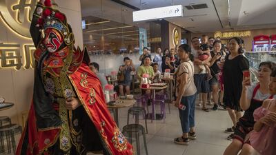 A traditional Chinese mask show at a Haidilao restaurant   in Beijing. Photograph: Gilles Sabrié/ The New York Times