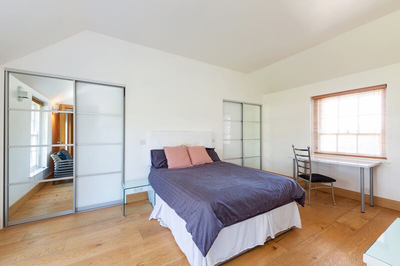 The Main bedroom has oak flooring and fitted Sliderobes.