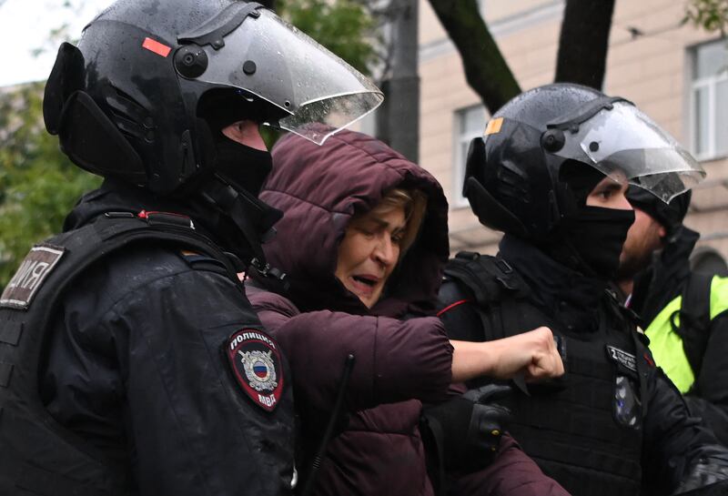 Police officers detain a woman in Moscow on Saturday following calls to protest against the partial mobilisation announced by Putin. Photograph: AFP via Getty Images