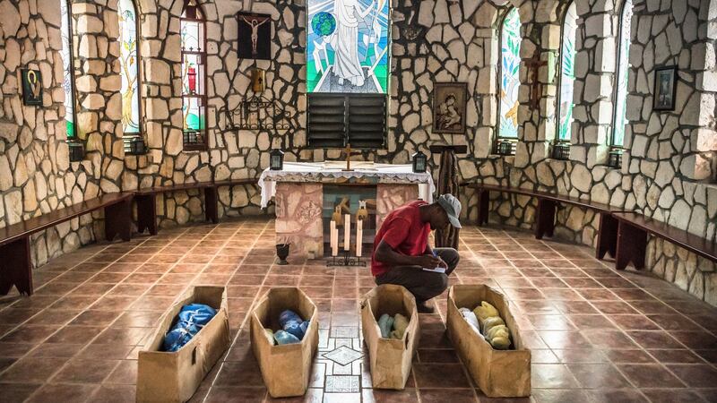 Renald Jameau from the St Luke Foundation writes down the names of children who died overnight at St Damien Children’s Hospital, in Port-au-Prince, Haiti. Photograph: Daniel Berehulak/The New York Times