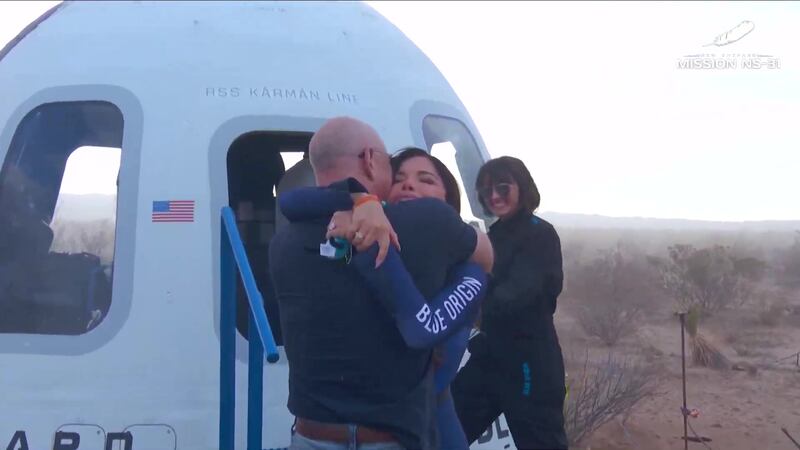 Screen grab taken from Blue Origin on YouTube of Lauren Sanchez hugging her partner Jeff Bezos after her flight in Blue Origin's New Shepard NS-31 spaceship