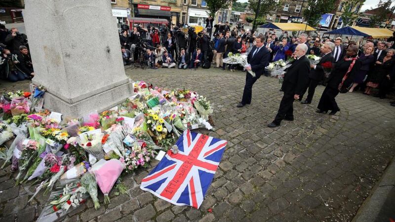 British prime minister David Cameron (left foreground) and Labour Leader Jeremy Corbyn leave flowers today near the scene where British Labour MP Jo Cox was shot and fatally wounded in Birstall, Britain. Photograph: Nigel Roddis/EPA