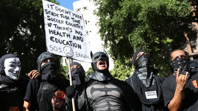 A person in a Batman costume holds a sign during a World Cup demonstration  in Rio de Janeiro, Brazil. Photograph: Joe Raedle/Getty Images