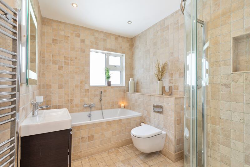 Main bathroom fully tiled in Italian Travertine stone