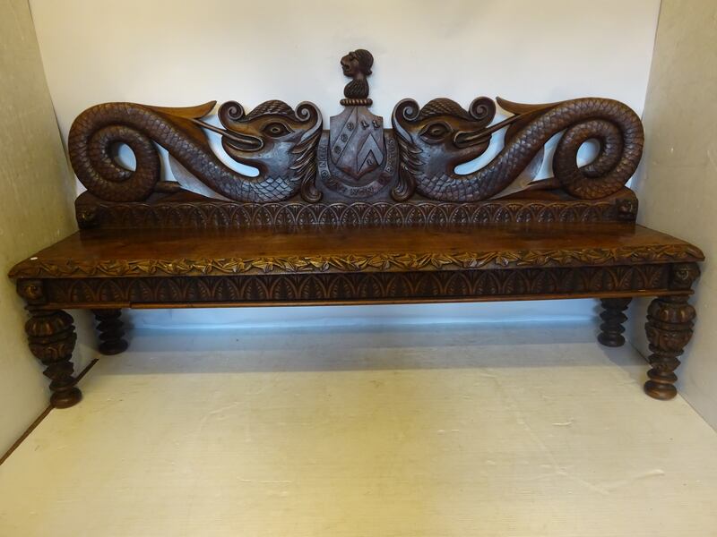 A long 19th century profusely carved walnut bench that Lynes and Lynes  values at €1,000-€1,500.