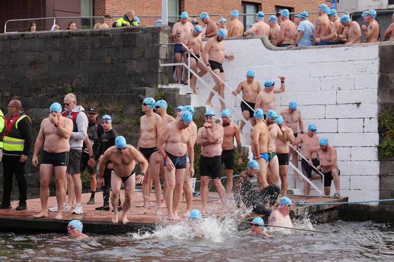 Some swimmers sang Molly Malone as they took the plunge at the start of the 105th Liffey Swim. Photograph: Alan Betson/The Irish Times

