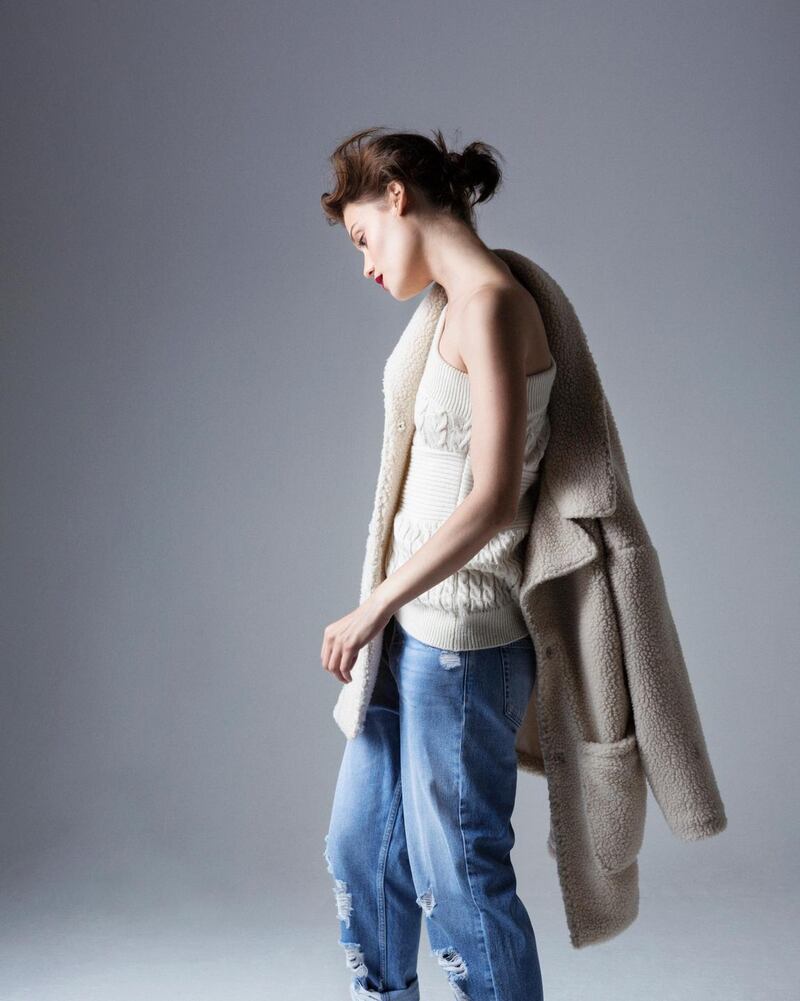 Faux shearling coat €30, one-shoulder knit €16, cropped jeans €19.