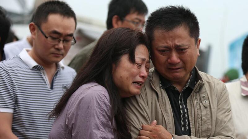 Relatives of victims of a capsized tourist ship cry on the banks of the Yangtze River in Jianli, Hubei province, China, on Thursday. There were 456 on board the Eastern Star when it sank in bad weather June 1st. Photograph: Wu Hong/EPA