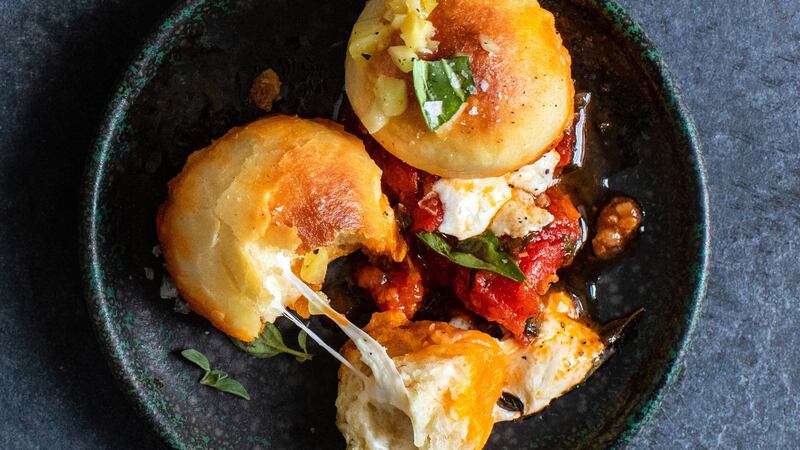 Cheesy bread balls in tomato sauce. Photograph: Andrew Scrivani/The New York Times