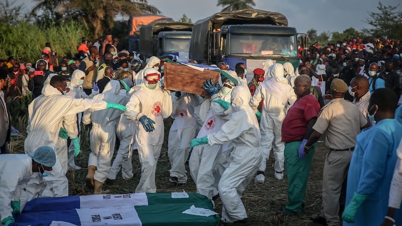 Coffins are taken off trucks ahead of the  mass burial of  victims of Freetown’s fuel tanker explosion. Photograph: Sally Hayden