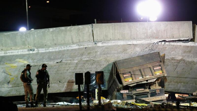 A vehicle is trapped underneath a bridge that collapsed while under construction in Belo Horizonte, Brazil yesterday. Photograph: Ivan Alvarado/Reuters.