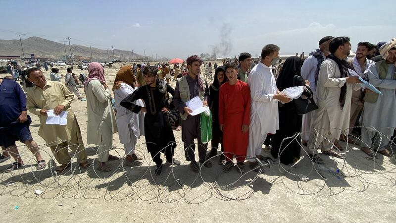 Afghans including those who worked for the US, NATO, Europe Union and the United Nations in Afghanistan wait outside the Hamid Karzai International Airport to flee the country. Photograph: EPA