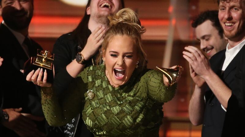 Adele breaks the Grammy for Record of the Year for Hello after having it presented to her at the 59th Annual Grammy Awards in Los Angeles. Photograph:   Lucy Nicholson/Reuters