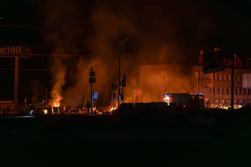 Rescue workers extinguish a fire at the site of a Russian drone attack in Kharkiv. Photograph: Alex Babenko/AP