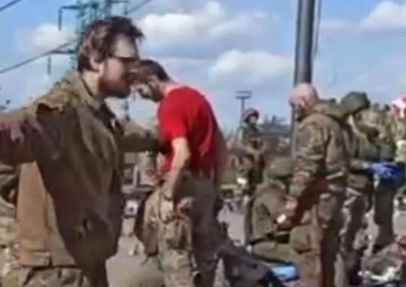 The parents of Ukrainian border guard Mark believe this footage from Russian state television shows him (in the red t-shirt) being searched after leaving the Azovstal factory in Mariupol in May. Photograph courtesy Mark's family.