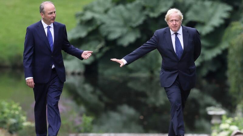 Taoiseach Micheál Martin and British prime minister Boris Johnson walk and talk in Hillsborough Castle gardens. Photograph:  Brian Lawless