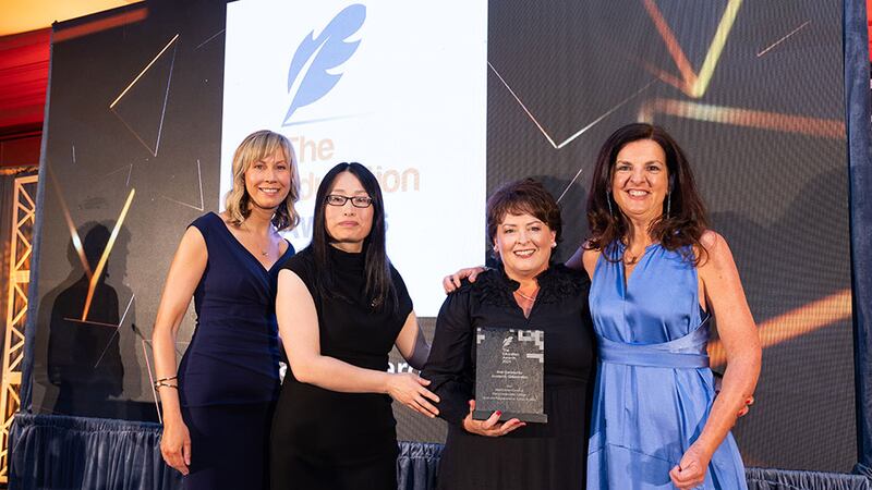 Yuxin Wang, awards judge, presents the best community academic collaboration award to the Middletown Centre for Autism & Mary Immaculate College team