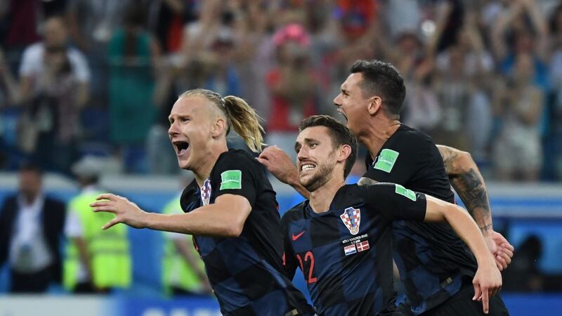 Croatia’s defenders Domagoj Vida, Josip Pivaric and Dejan Lovren celebrate after they won the penalty shootout in the   World Cup round of 16 football match against Denmark  at the Nizhny Novgorod Stadium. Photograph: Dimitar Dilkoff/AFP/Getty Images