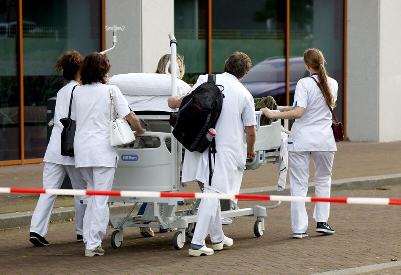 Medical staff push a patient on a hospital bed at the Erasmus University Medical Center in Rotterdam, which was cordoned off after two reported shooting incidents. Photograph: Bas Czerwinski/AFP/Getty