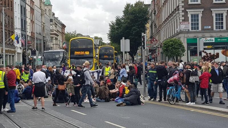 Housing protesters staging a sit-down protest on O’Connell Bridge in Dublin City Centre on Saturday. Photograph: Kitty Holland
