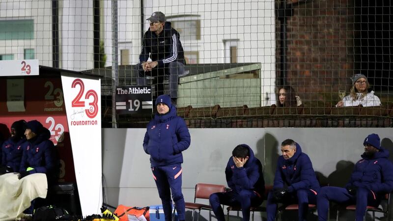 Tottenham manager Jose Mourinho watches the game as fans are seen watching the FA Cup tie against Marine from their back gardens. Photograph: Clive Brunskill/Getty Images