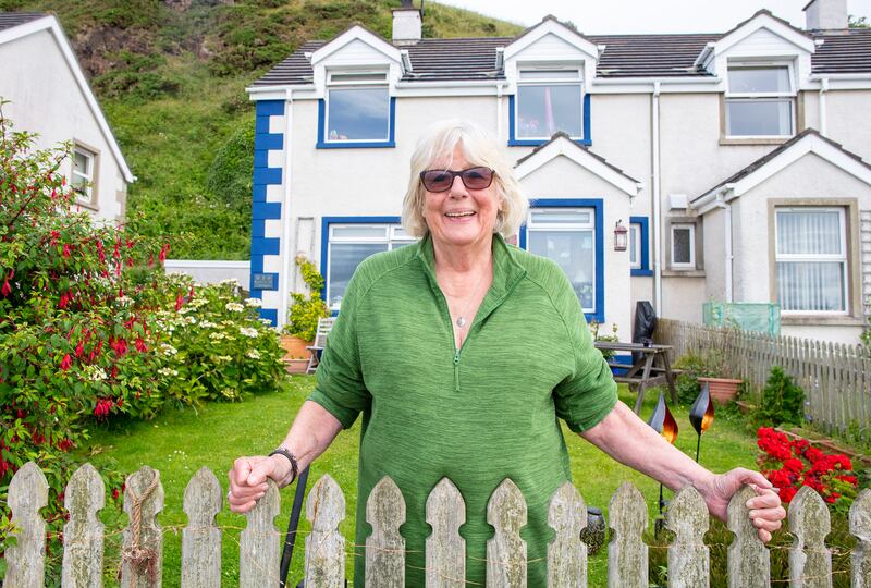 Rathlin Island resident Nicky Sebastian outside her harbour-front home. Photograph: Paul Faith